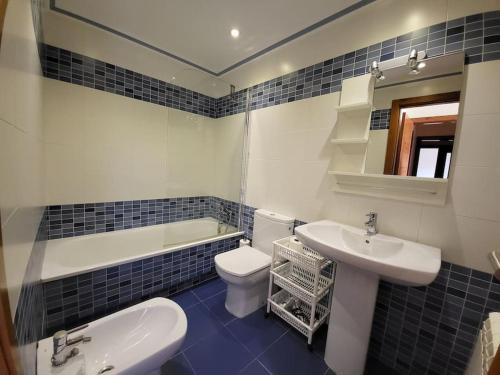 La salle de bains est pourvue d'un lavabo, de toilettes et d'une baignoire. dans l'établissement Apartment with direct access to the beach(WIFI), à Sanxenxo