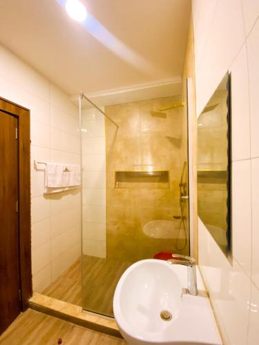 a bathroom with a sink and a shower at Service apartment is Abuja in Abuja