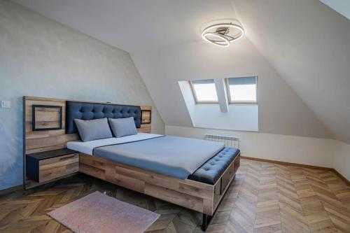 a bedroom with a large bed in a attic at 20% Discount! 2 Bedroom Apartment Vitosha View in Sofia