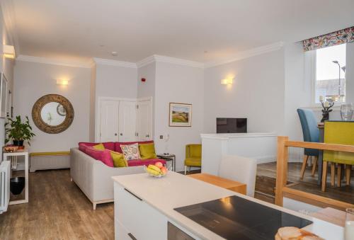 a living room with a couch and a table at The Kinross Residence in Kinross