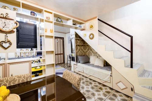 a room with a staircase with a bed under it at Lovely Nest Townhouse in Clark