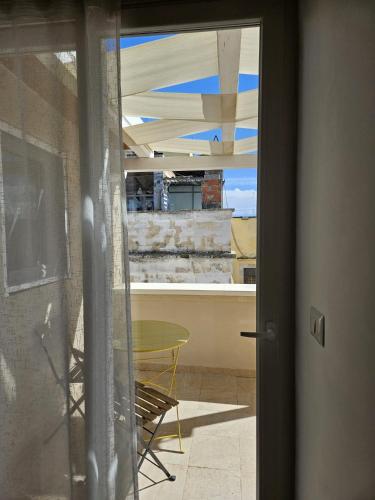 a door to a room with a view of a table at Santalucia Apartment in Modugno