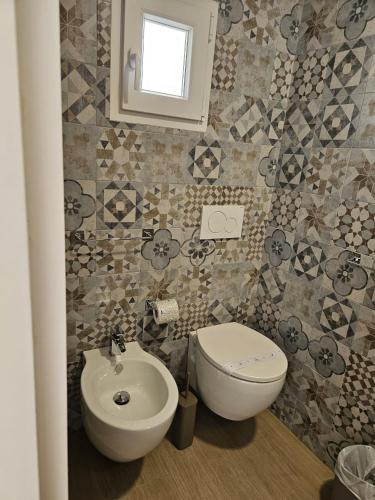 a bathroom with a toilet and a sink at Santalucia Apartment in Modugno