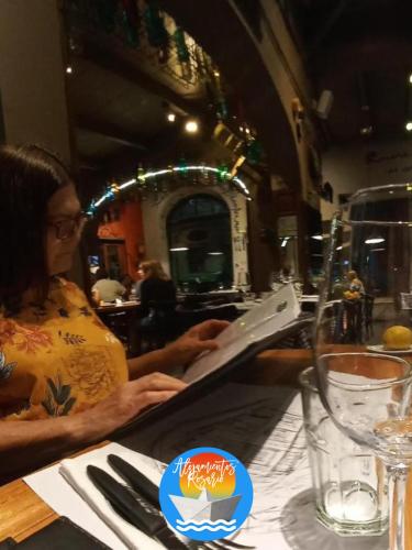 a woman sitting at a table in a restaurant at DEPTO CON VISTA AL RIO!! UBICACION IDEAL!! PRECIO UNICOi! in Rosario