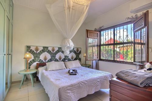 a bedroom with a bed with a stuffed animal on it at Villa La Luz in Sainte-Anne