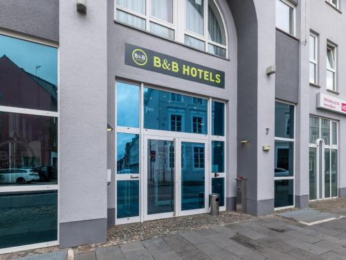 a building with the entrance to a bbc hotel at B&B HOTEL Eschweiler in Eschweiler