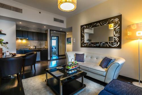 a living room with a couch and a table at First Central Hotel Suites in Dubai