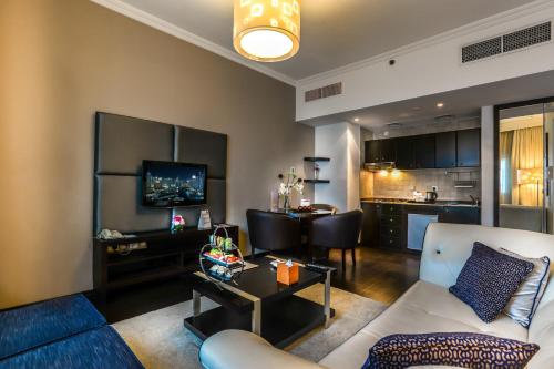 a living room with a couch and a table at First Central Hotel Suites in Dubai