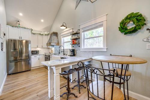 a kitchen with white cabinets and a counter top at Byron Getaway with Fire Pit - Near MGA and Mercer! in Byron