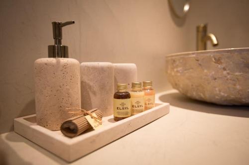 a bathroom counter with two rolls of toilet paper and a sink at Ontspan huisje: wellness in de natuur in Lanaken