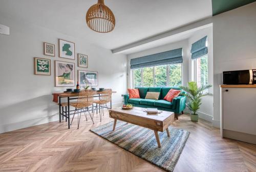 a living room with a couch and a table at First Floor - Stylish 3 Bedroom Apartment in Southampton
