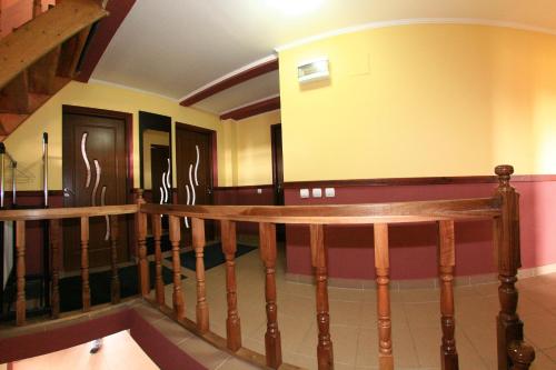 a room with a wooden railing and a staircase at Piatra Rancii in Ranca