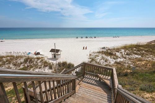 a wooden staircase leading to a beach with people on it at Amalfi Coast in Miramar Beach