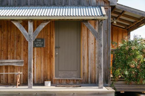 a wooden building with a door with a sign on it at Retreat East in Ipswich