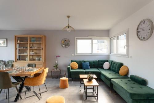 un salon avec un canapé vert et une table dans l'établissement Clou Beach - Jolie maison à Pléneuf-Val-André, à Pléneuf-Val-André