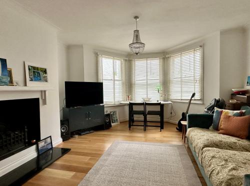 a living room with a couch and a table at Seafront Medina in Brighton & Hove