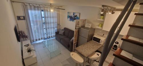 an aerial view of a living room with a couch at Playmar Sun Maspalomas in Playa del Ingles