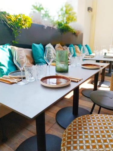 a table with glasses and plates on top of it at Novotel Bordeaux Centre Ville in Bordeaux