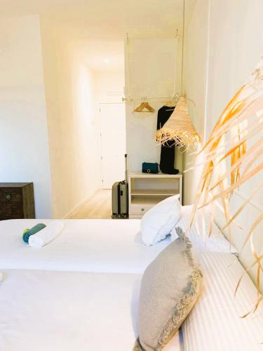 a bedroom with a white bed with pillows at COLLECTION PORT - B&B Boutique , Alicante Center in Alicante