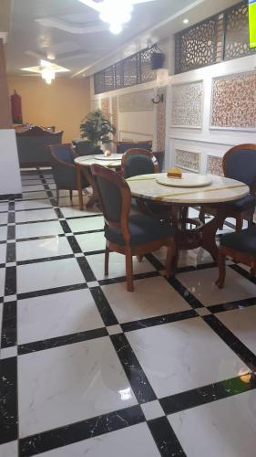 a dining room with a table and chairs on a checkered floor at THE MARK HOTEL in Nairobi