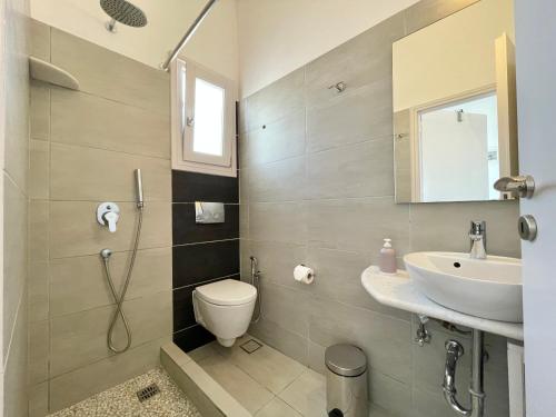 a bathroom with a toilet and a sink at Anna's Studio in Piso Livadi