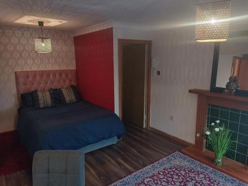 - une chambre avec un lit, un canapé et une cheminée dans l'établissement Open space studio in Shawlands, à Glasgow