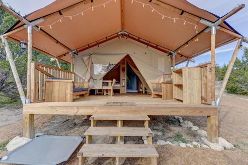 a tent with a table and benches in front of it at Tent #3 - Glamping on a Winery in Texas Hill Country in Johnson City