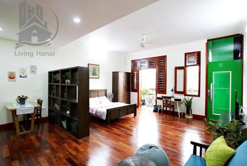 a living room with a bed and a table at Splendor Trendy Aparment in Hanoi