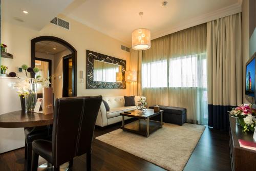 a living room with a couch and a table at First Central Hotel Suites in Dubai