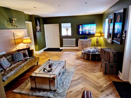 a living room with a couch and a table at The Hamilton luxury holiday let's- The Coach House with hot tub in Scorton