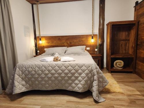 a bedroom with a bed with a stuffed animal on it at POUSADA SERTÃO DA BOCAINA in Cunha
