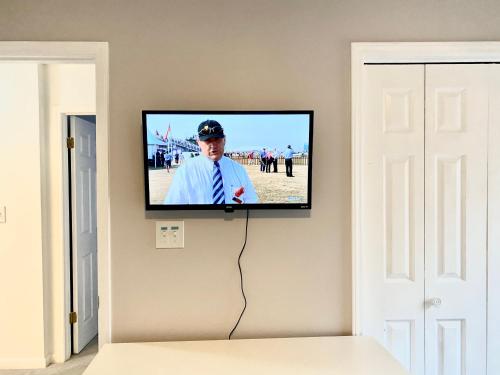 a flat screen tv hanging on a wall at Golf Front SFH, 3 BR, 2 BA, 4 beds, sleep 6 on Pinehurst #6 in Pinehurst