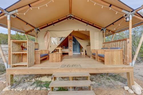 a tent with a wooden floor and a table and benches at 12 Fires Luxury Glamping with AC #4 in Johnson City