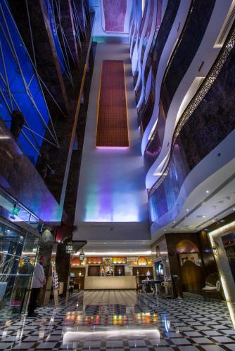 an empty lobby with a long escalator in a building at First Central Hotel Suites in Dubai