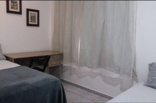 Ένα ή περισσότερα κρεβάτια σε δωμάτιο στο Casa Agradável, Arejada, Espaçosa, Perto de Tudo e Para até 20 Pessoas