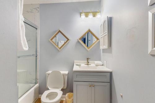 a white bathroom with a toilet and a sink at Plantation East #3219 in Gulf Highlands
