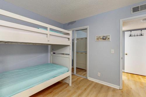 a bedroom with two bunk beds and a closet at Plantation East #3219 in Gulf Highlands