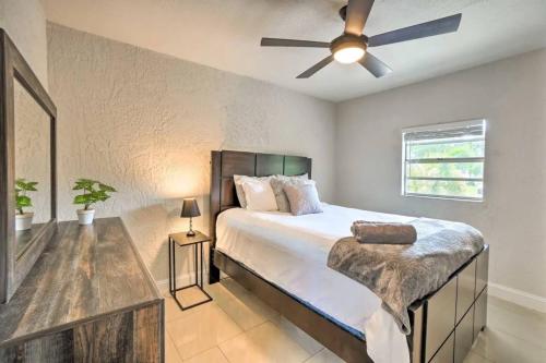 a bedroom with a bed and a ceiling fan at Backyard Oasis! 2 mi to Pier with Pool, Patio Bar & Putting Green in Safety Harbor
