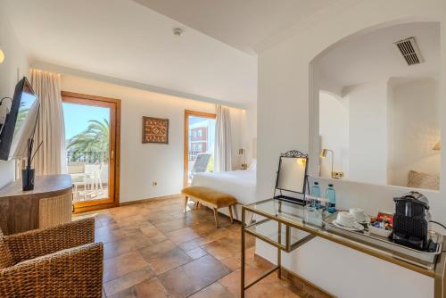 a hotel room with a bed and a living room at La Posada del Mar in Denia