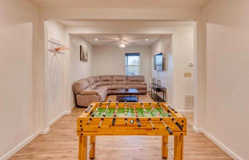 a living room with a table in front of a couch at 7 Min to DT Blue Ridge~Hot Tub~Fire Pit~Sleeps 12 in Blue Ridge