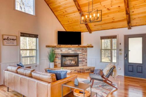 a living room with a couch and a fireplace at 7 Min to DT Blue Ridge~Hot Tub~Fire Pit~Sleeps 12 in Blue Ridge
