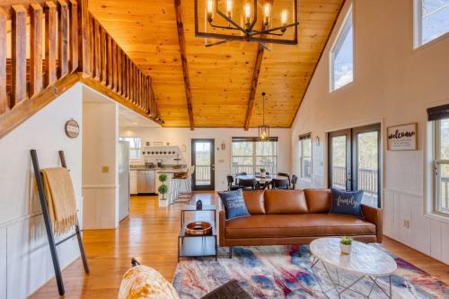 a living room with a couch and a table at 7 Min to DT Blue Ridge~Hot Tub~Fire Pit~Sleeps 12 in Blue Ridge