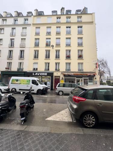 a parking lot with cars parked in front of a building at Studio Montmartre in Paris