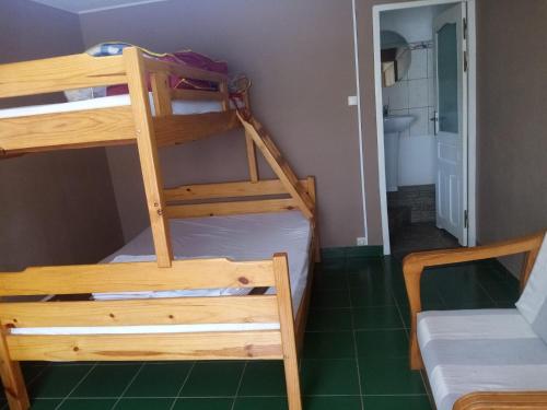 a room with two bunk beds and a bathroom at Tendry Guest House in Antananarivo