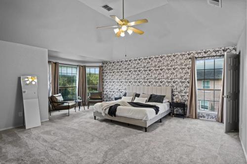 a bedroom with a bed and a ceiling fan at Heated Pool PoolTable HotTub Sleeps 16 Renovated in McKinney