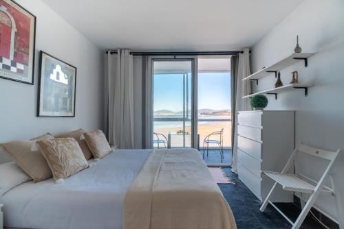 a bedroom with a bed and a view of the ocean at El Balcón de Samil in Vigo
