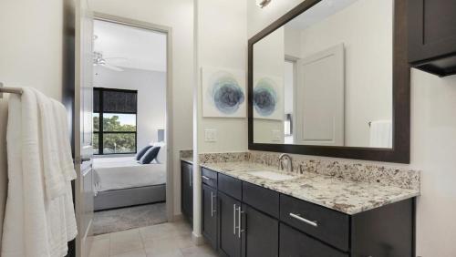 a bathroom with a sink and a mirror at Landing - Modern Apartment with Amazing Amenities (ID1414) in Houston