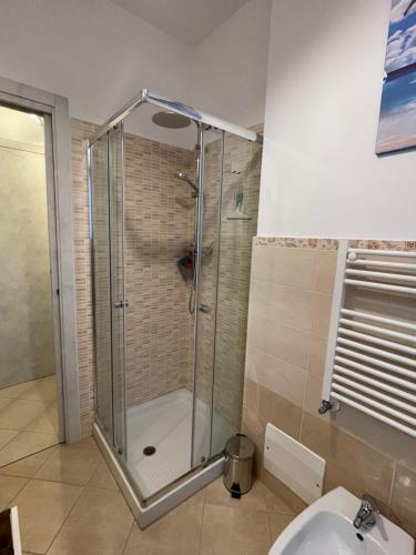 a shower with a glass door in a bathroom at il Nido sul lago Trasimeno in Castiglione del Lago