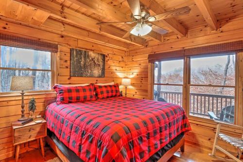 a bedroom with a bed in a log cabin at Pet-Friendly Mountain Retreat Fire Pit Hot Tub in Blue Ridge