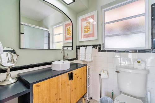 a bathroom with a sink and a toilet at SoFlo Oasis 6 min to Beach Pool BBQ in Fort Lauderdale
